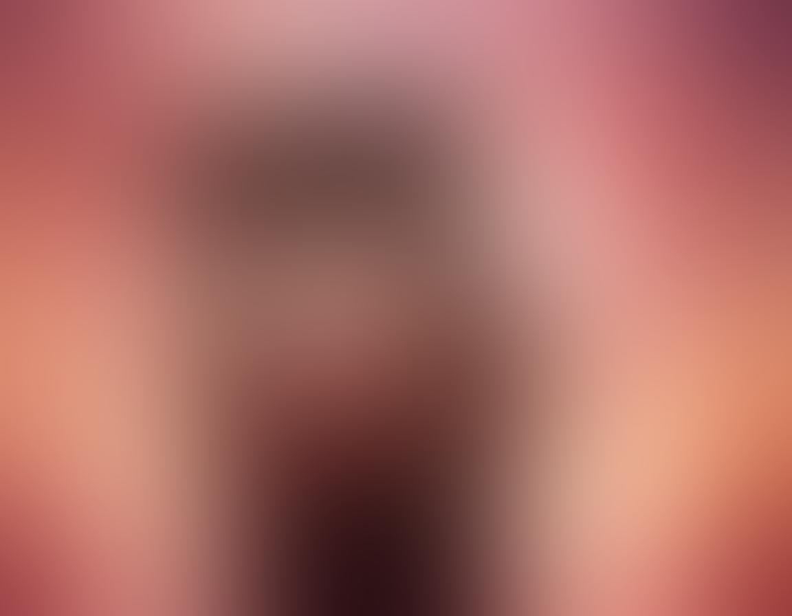 A surreal depiction of two silhouettes entwined in a soft embrace, surrounded by ethereal elements like glowing hearts and delicate petals, symbolizing intimacy and connection. The background should be a dreamy blend of warm colors like soft pinks and deep purples, suggesting passion and warmth. Incorporate subtle hints of light streaming down, creating an aura of serenity and love. The overall feel should inspire a sense of closeness and exploration of sensual experiences. surrealistic. warm color palette. dreamy background.